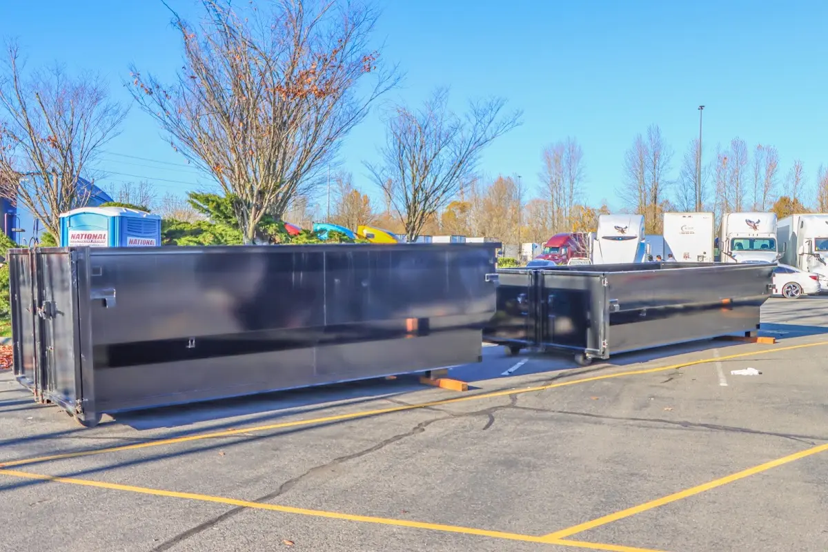 Professional dumpster rental service with roll-off container on residential driveway in Clarendon Hills